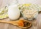 Oat flakes in transparent bowl, jug milk, napkin and spoon