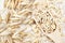 Oat groat in wooden spoon, oatmeal grain for healthy diet on oat ears plants background