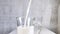Oat milk in transparent cup with handle. Vegan alternative to cow dairy products. Opaque creamy drink is poured into glass. Close-
