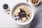 Oat porridge with banana, blueberry, walnut, milk for healthy breakfast