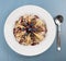 Oatmeal with apples, black berries, nuts and topping