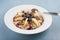 Oatmeal with apples, black berries, nuts and topping