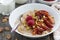 Oatmeal with baked fruit and pistachios for breakfast, closeup