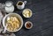 Oatmeal with banana, caramel sauce and pecan nuts in a white bowl on a dark wooden surface