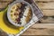 Oatmeal with bananas, cranberry, chia seeds, coconut shreds, almonds. Healthy breakfast concept. Rustic wooden background.