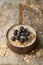 Oatmeal with Blueberries in Copper Saucepan on Weathered Stainless Steel Surface