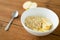 Oatmeal in bowl with apple and spoon on table