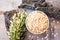 Oatmeal in the bowl and ears of oats on a piece of bark tree