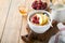 Oatmeal. Bowl of oatmeal porridge with raspberry, pear and honey on old wooden table background. Hot and healthy food for