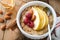 Oatmeal. Bowl of oatmeal porridge with raspberry, pear and honey on old wooden table background. Hot and healthy food for