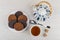 Oatmeal cookies with chocolate, teapot, teaspoon, sugar and tea