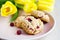 Oatmeal cookies with cranberries and cereals, with yellow tulips. morning bouquet and breakfast