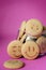 Oatmeal cookies in the form of an emoticon on a pink background. Shortbread cookie for breakfast. Baby biscuits for snacks