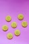 Oatmeal cookies in the form of an emoticon on a pink background. Shortbread cookie for breakfast. Baby biscuits for snacks