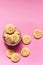 Oatmeal cookies in the form of an emoticon on a pink background. Shortbread cookie for breakfast. Baby biscuits for snacks