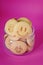 Oatmeal cookies in the form of an emoticon on a pink background. Shortbread cookie for breakfast. Baby biscuits for snacks