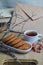 Oatmeal cookies with hot tea on a natural wood desk. Winter composition for the interior with snow-covered branches and