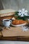 Oatmeal cookies with hot tea on a natural wood kitchen board. Winter composition for the interior with snow-covered