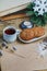 Oatmeal cookies with hot tea on a natural wood kitchen board. Winter composition for the interior with snow-covered