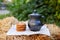 Oatmeal cookies with Milk jug on straw in field. Milk in clay jug. Organic product. Concept natural products, healthy food. Still