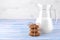 Oatmeal cookies piled in the stack in the foreground and milk in a glass on a blue wooden table. bake. yummy