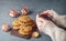 Oatmeal cookies with prunes and girl\'s hands covering pink tea