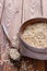 Oatmeal in a cup and spoon closeup vertically