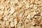 Oatmeal flakes texture on whole background close up