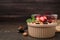 Oatmeal with freeze dried fruits, nuts and mint on wooden table, closeup. Space for text