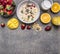 Oatmeal with fruit and freshly squeezed orange juice border ,place for text wooden rustic background top view close up