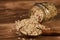 Oatmeal glass jar and wooden spoon with oat flakes