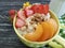 oatmeal, nuts, strawberry, apricot eating on a black wooden background