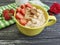 Oatmeal, nuts, strawberry on a black wooden background