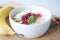 Oatmeal porridge with banana, ripe raspberries and pumpkin seeds