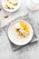 Oatmeal porridge with banana slices, almond and dried apricot