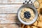 Oatmeal porridge with blueberries and almonds. White wooden background. Top view. Copy space