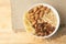 Oatmeal with raisins banana and almonds. White cup