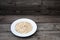 Oatmeal, rolled oats on rustic white wooden background. Food Co