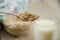 Oatmeal on a spoon against the background of a glass of milk and a plate of porridge. Close-up.