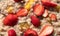Oatmeal with strawberries, peaches and other fruits and nuts.