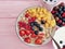 oatmeal, strawberry, raspberry apricot dessert healthy blueberry antioxidant yogurt on a pink wooden background