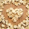 Oats in heart shape arranged on wood grain in square format for social media, banners and backgrounds.