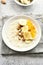 Oats porridge with banana slices, almond and dried apricot