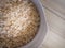 The oats rice in white bowl on top table wood worm tone image