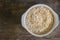 The oats rice in white bowl on top table wood worm tone image