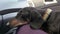 Obedient tired dachshund dog calmly tolerates traveling by car, so it sleeps quietly on lap of owner during journey in