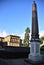 Obelisk, silhouetted in the blue sky, inside Palazzo Pitti in Florence.