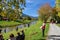OBERAMMERGAU, GERMANY - OKTOBER 09, 2018: Resting people on a lawn by the river in the autumn in the village