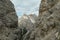 Oberbachernspitze - A sneak-peak on a high and distant mountain in Italian Dolomites. The mountain is visible between two slopes