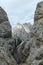 Oberbachernspitze - A sneak-peak on a high and distant mountain in Italian Dolomites. The mountain is visible between two slopes